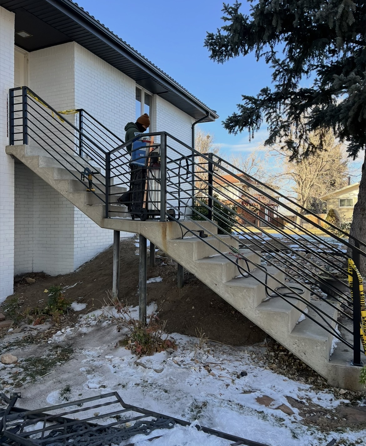 Installing horizontal-bar steel railing on concrete stairs