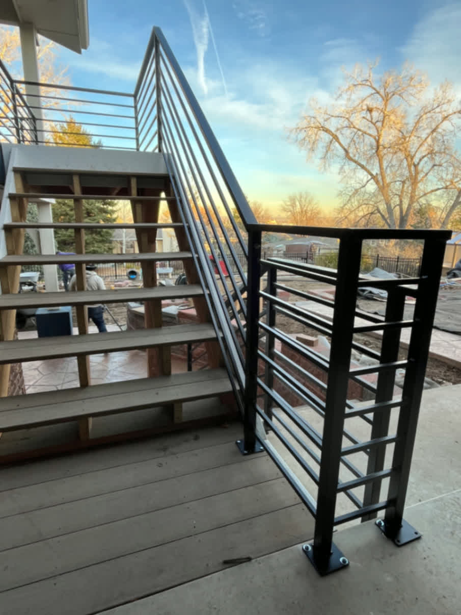 Modern black steel stair and deck railing with angled pickets