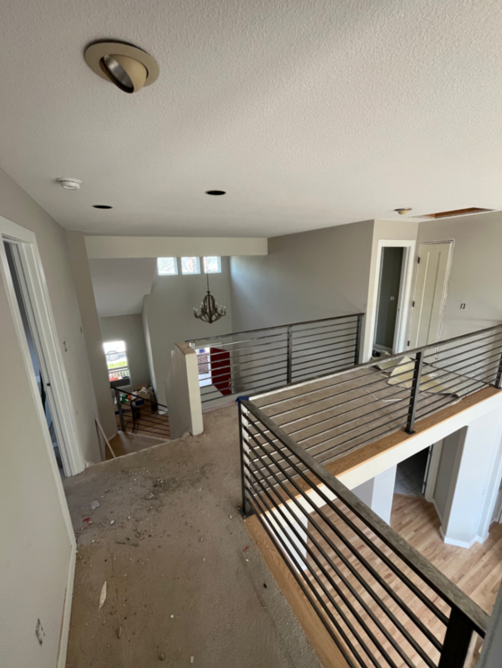 Interior loft horizontal-bar steel railing overlooking entry