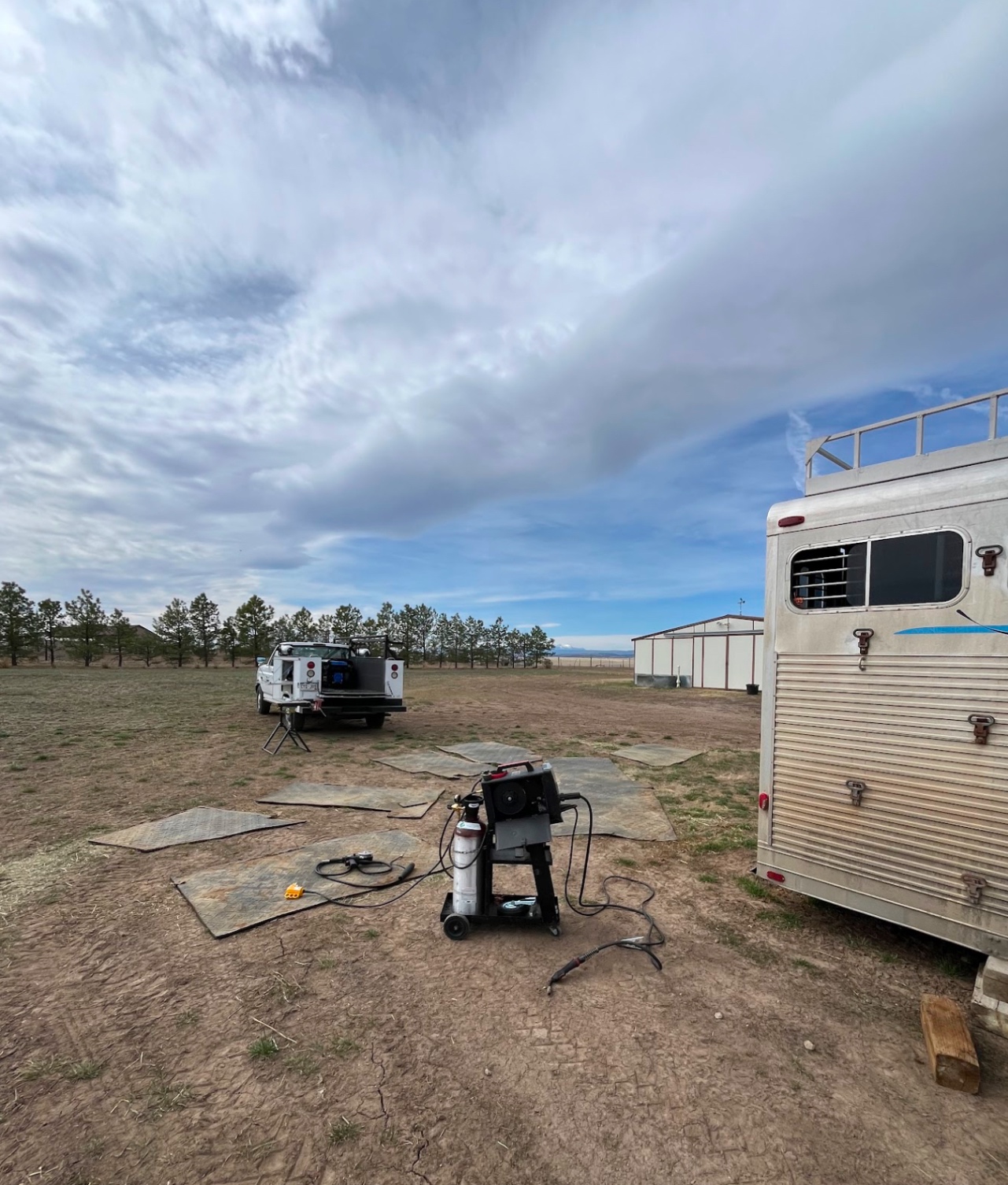Mobile welding rig set up in field for on-site trailer weld repair