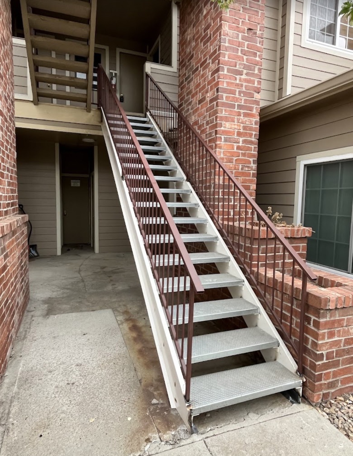 Steel apartment stairway with diamond-plate treads