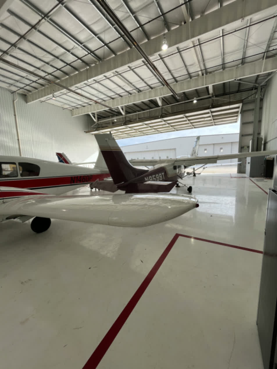 Aircraft metal fabrication and repair work inside aviation hangar