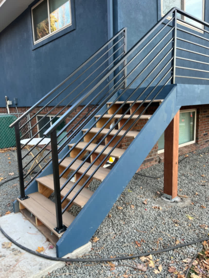 Modern horizontal-bar steel railing on exterior stairway and landing