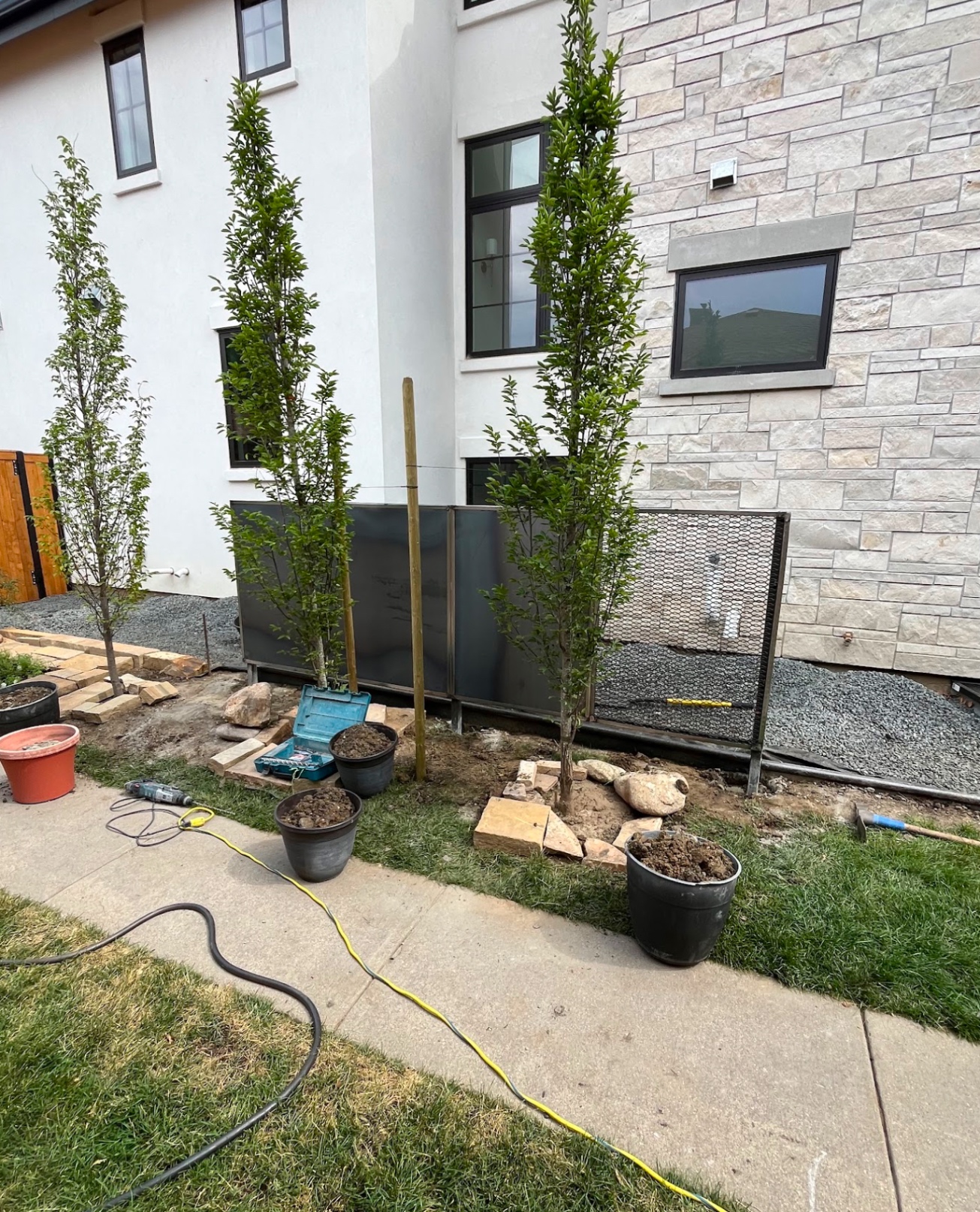 Custom steel HVAC screen and privacy panel along townhome walkway