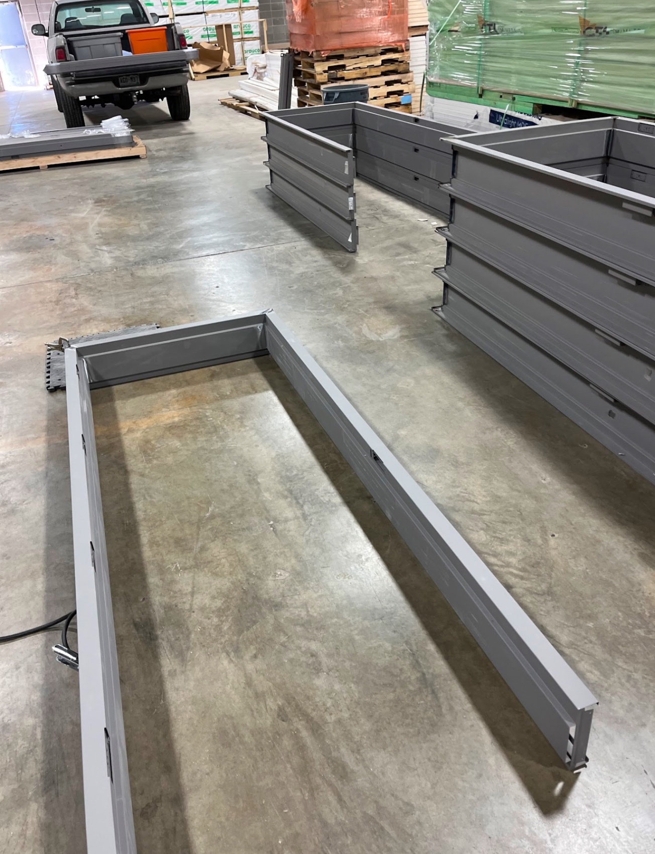 Custom powder-coated steel planter box frames in warehouse