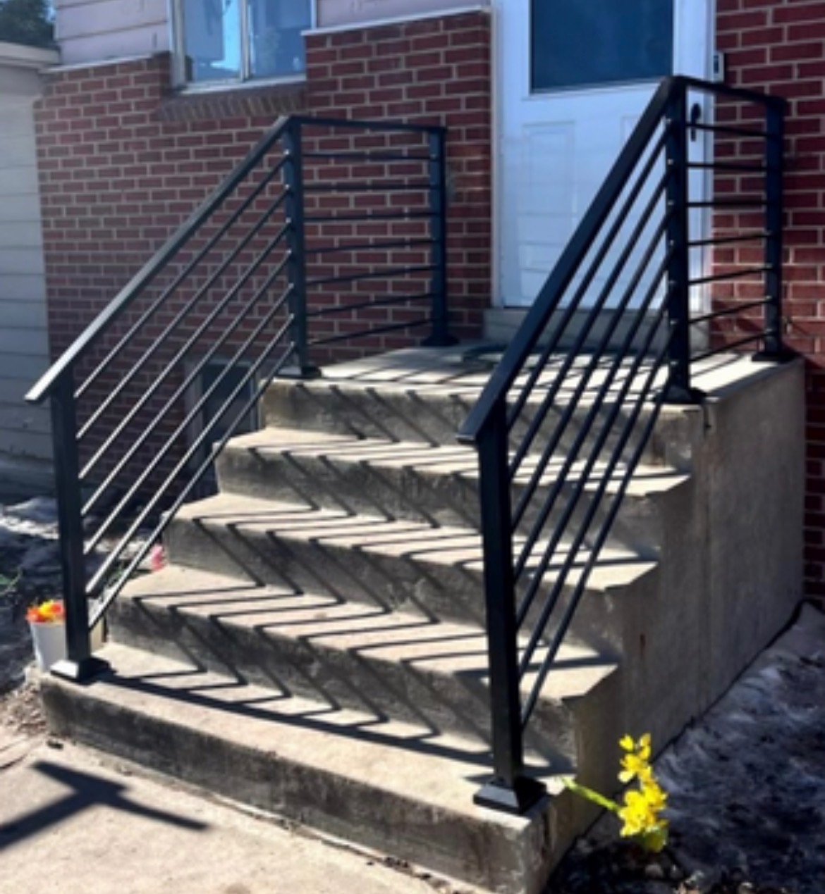 Custom steel handrail on brick steps