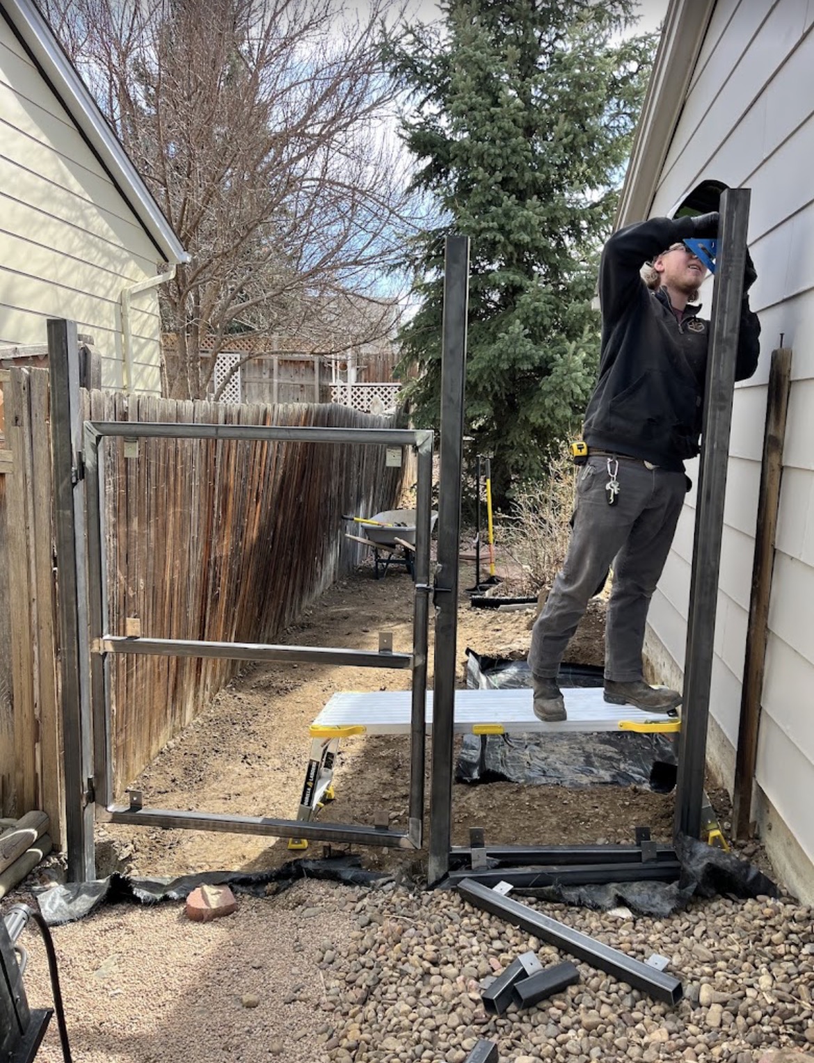 Installing steel gate frame in side yard