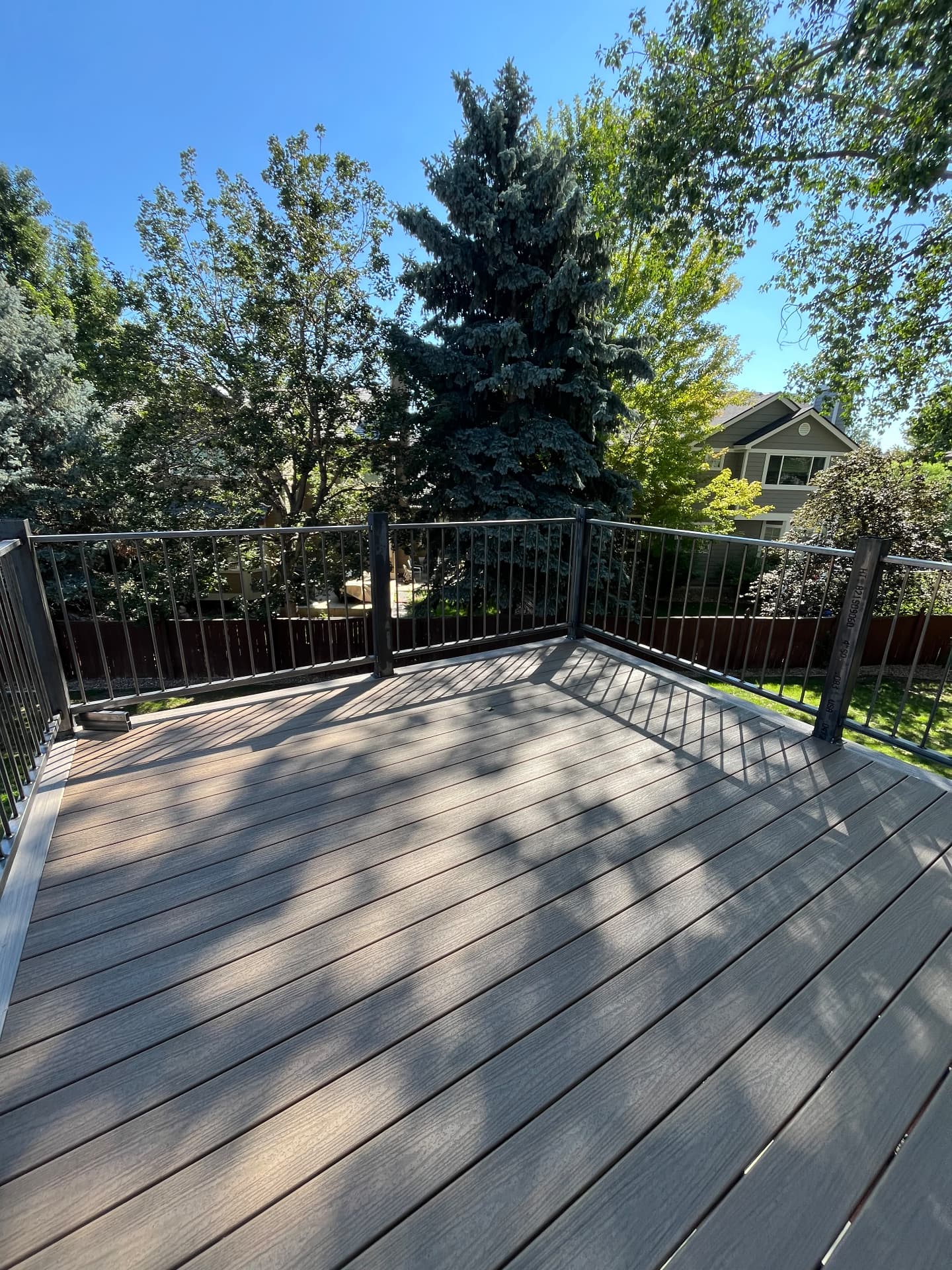 Corner detail of custom steel picket deck railing on composite decking
