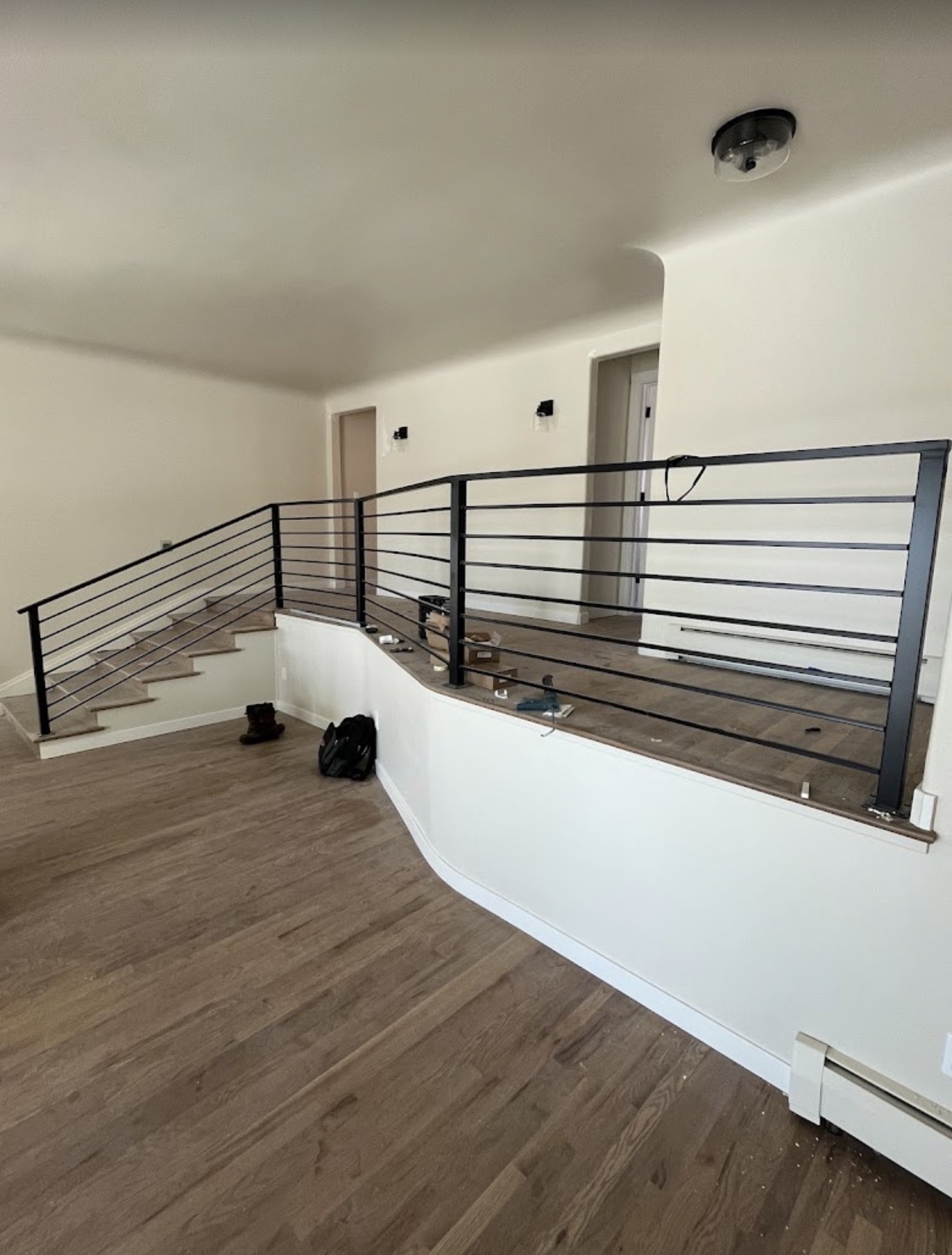 Interior horizontal-bar steel railing along staircase and landing