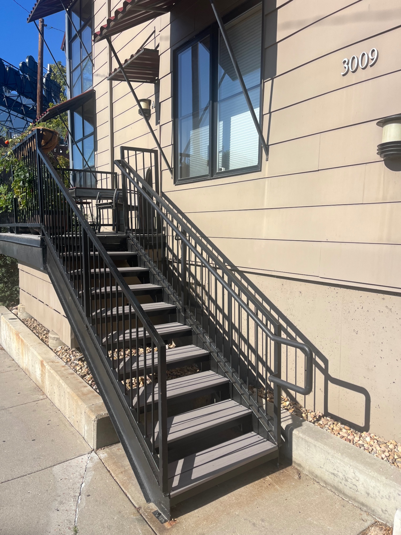 Steel stairway and railing at duplex entry with composite treads