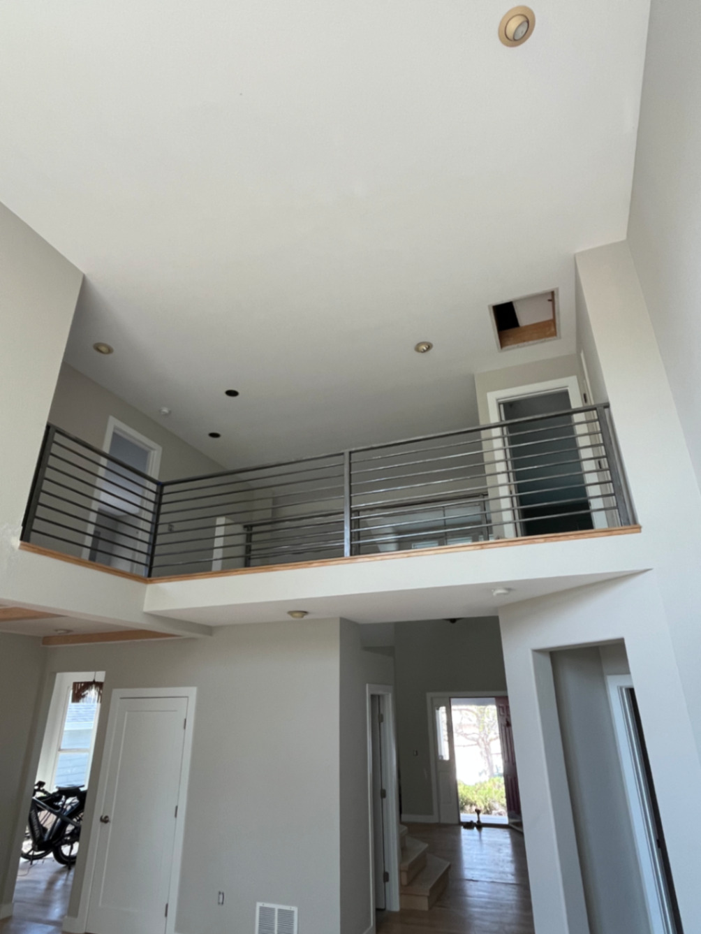 Two-story interior loft with modern horizontal steel railing