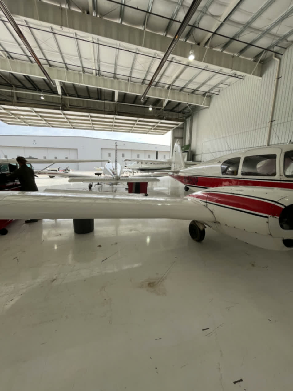 Aircraft fabrication work inside hangar with small planes