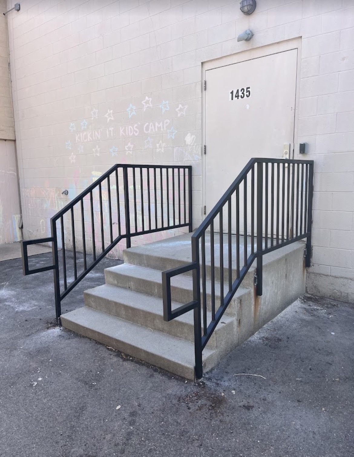 Black steel handrails on commercial concrete stairs
