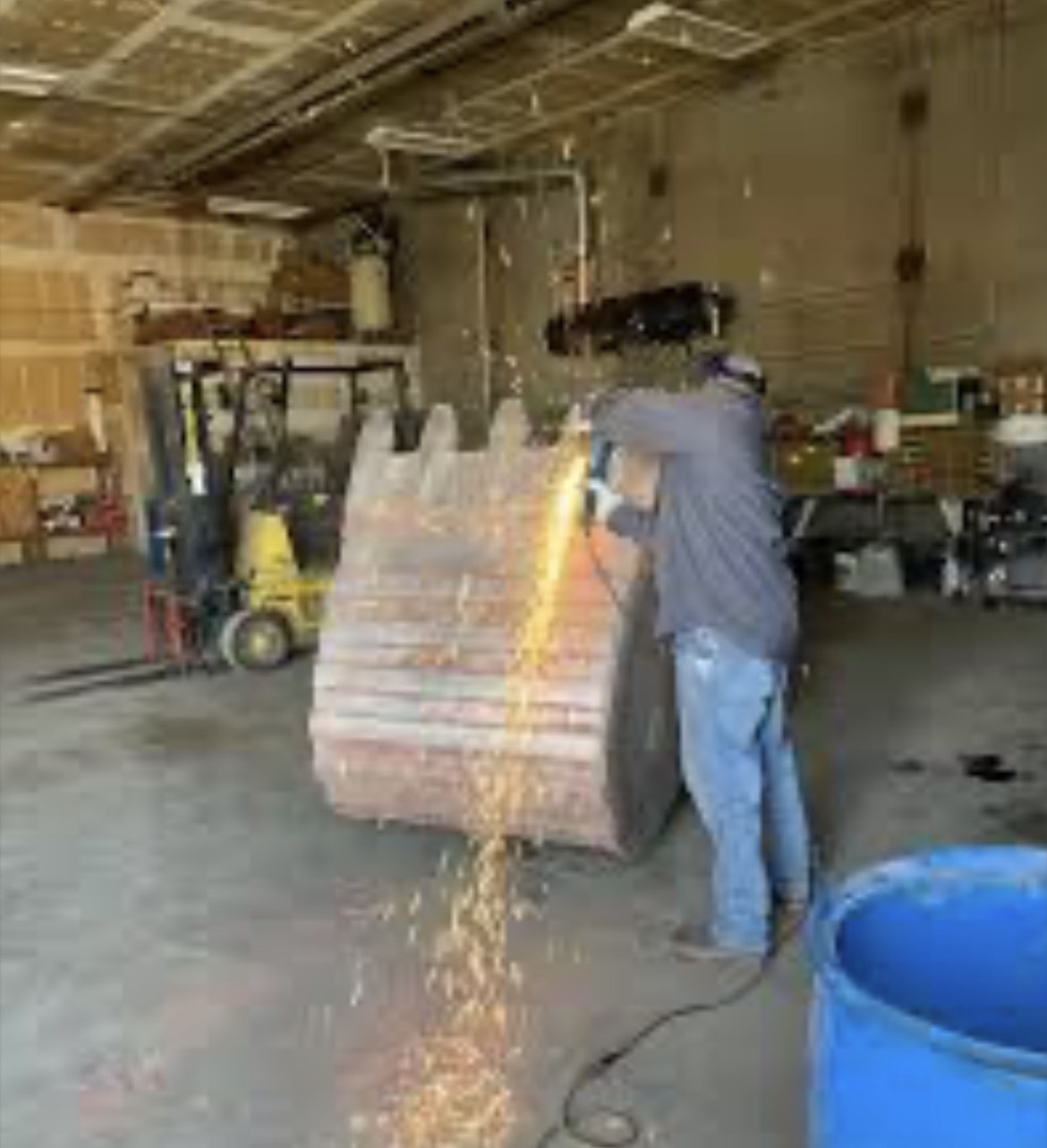 Heavy equipment bucket weld repair with sparks