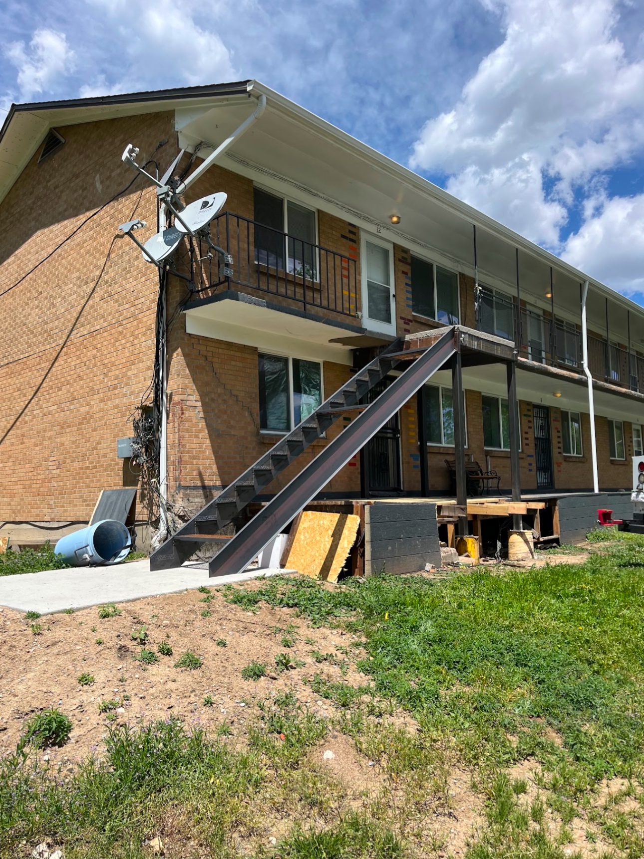 Completed steel exterior apartment stairway at rear of brick building