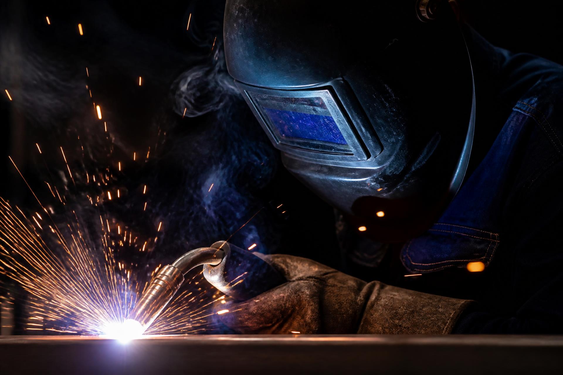 Welder at work with sparks flying